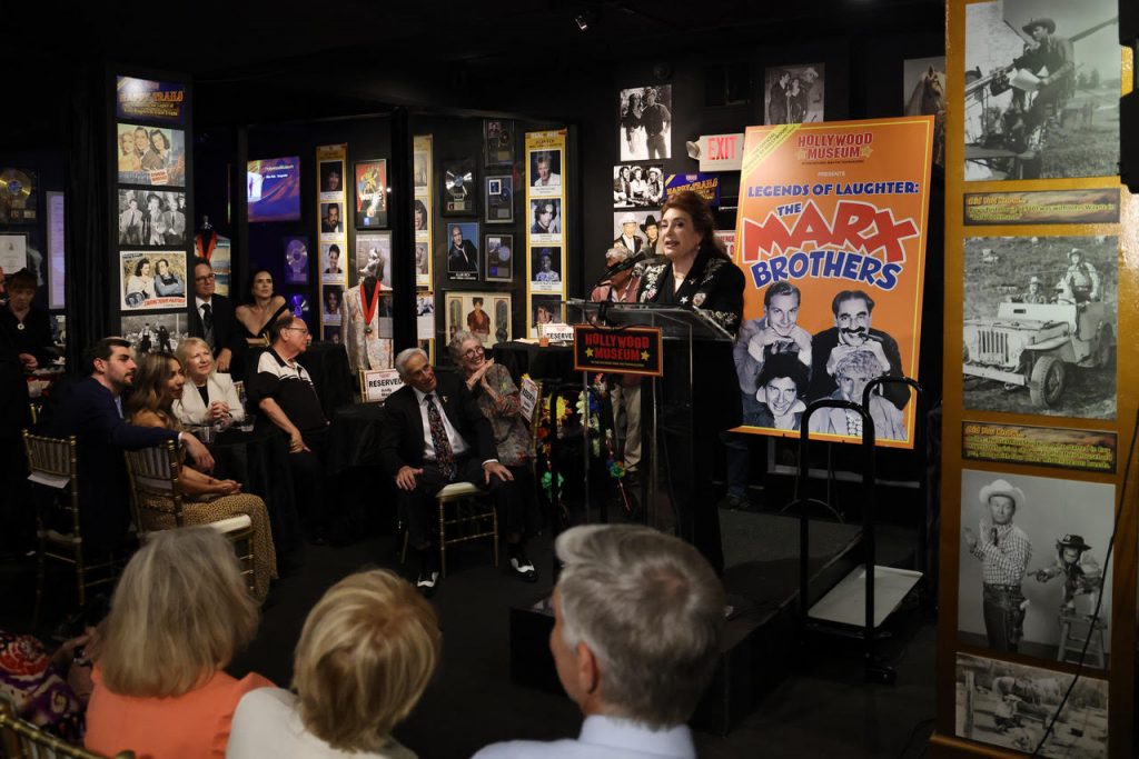 Host Donelle Dadigan (Founder/Preisdent of the Hollywood Museum) welcomes guests to the opening Photo Credit/Sheri Determan
