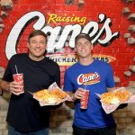 LOS ANGELES, CALIFORNIA - NOVEMBER 05: LA Dodgers Catcher Will Smith (R) poses with Raising Cane's CEO Todd Graves (L) during his Celebratory World Series "Shift" at Raising Cane'son November 05, 2025 in Los Angeles, California. (Photo by Charley Gallay/Getty Images for Raising Cane's)